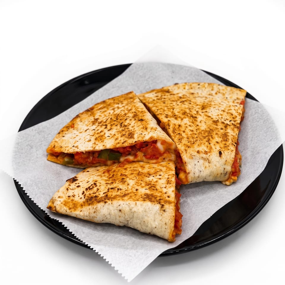 Three toasted, folded calzones filled with tomato sauce, melted cheese, and vegetables on a paper-lined black plate.